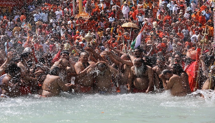 Sadhus, or Hindu holy men, take a dip in the Ganges river during