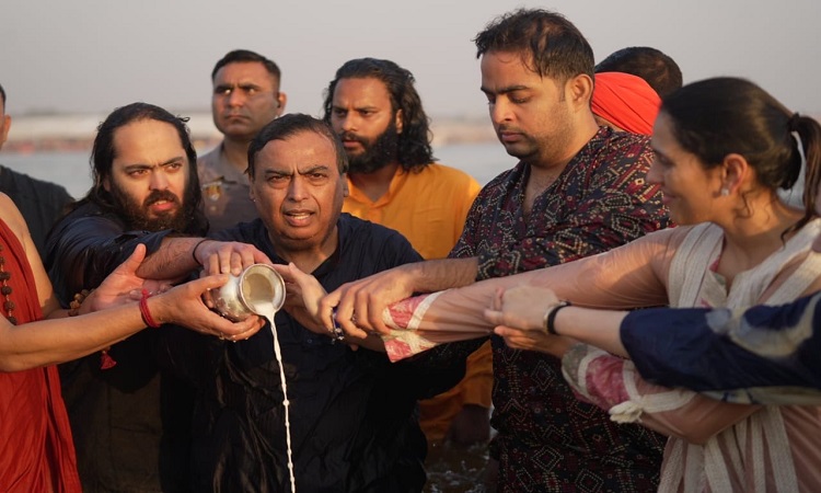 Mukesh Ambani and family take holy dip in Sangam